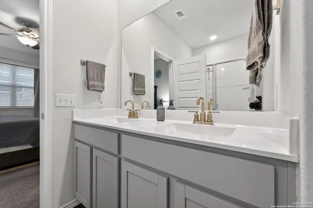 a bathroom with a sink double vanity and a mirror