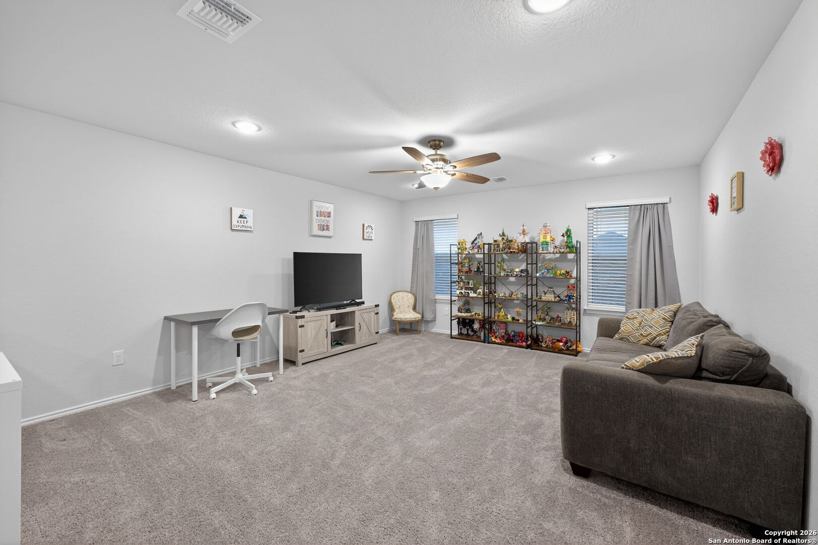 132 Bella Rosa Trail Cibolo, TX 78108 - Photo 37 of 49 a living room with furniture and a flat screen tv