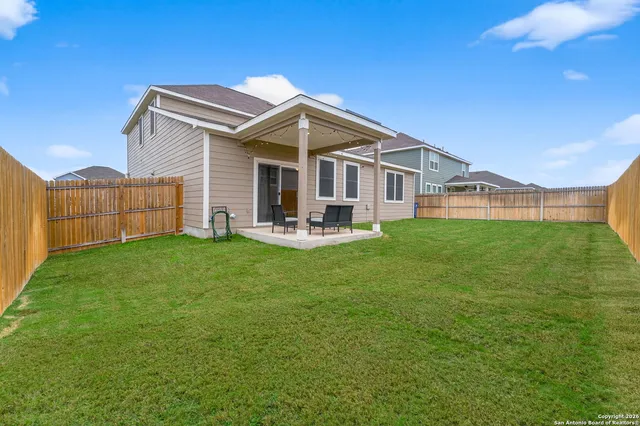 a front view of a house with a garden and yard