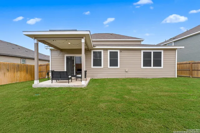 a view of a house with backyard and porch