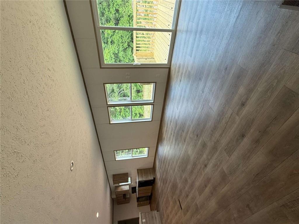 1052 Jones Ferry Road Elberton, GA 30635 - Photo 14 of 16 a view of an empty room with wooden floor and a window