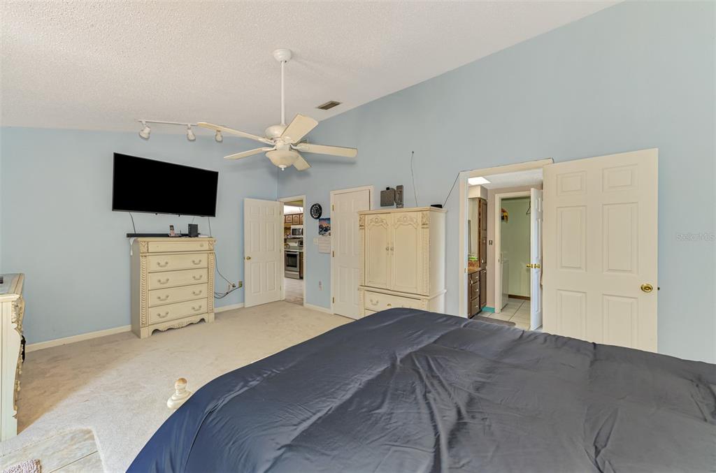 1137 Ponderosa Road Venice, FL 34293 - Photo 24 of 48 a bedroom with a bed and a flat screen tv