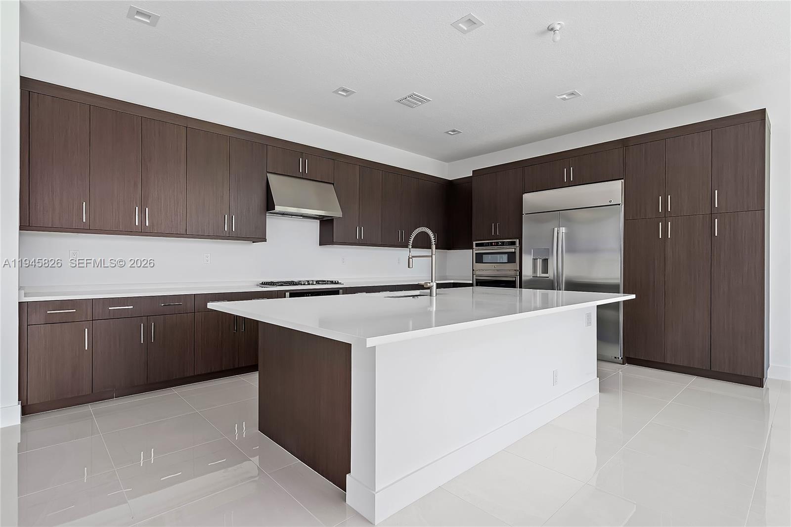 9362 Tulip Leaf Court Boca Raton, FL 33434 - Photo 2 of 80 a kitchen with stainless steel appliances a sink stove and cabinets