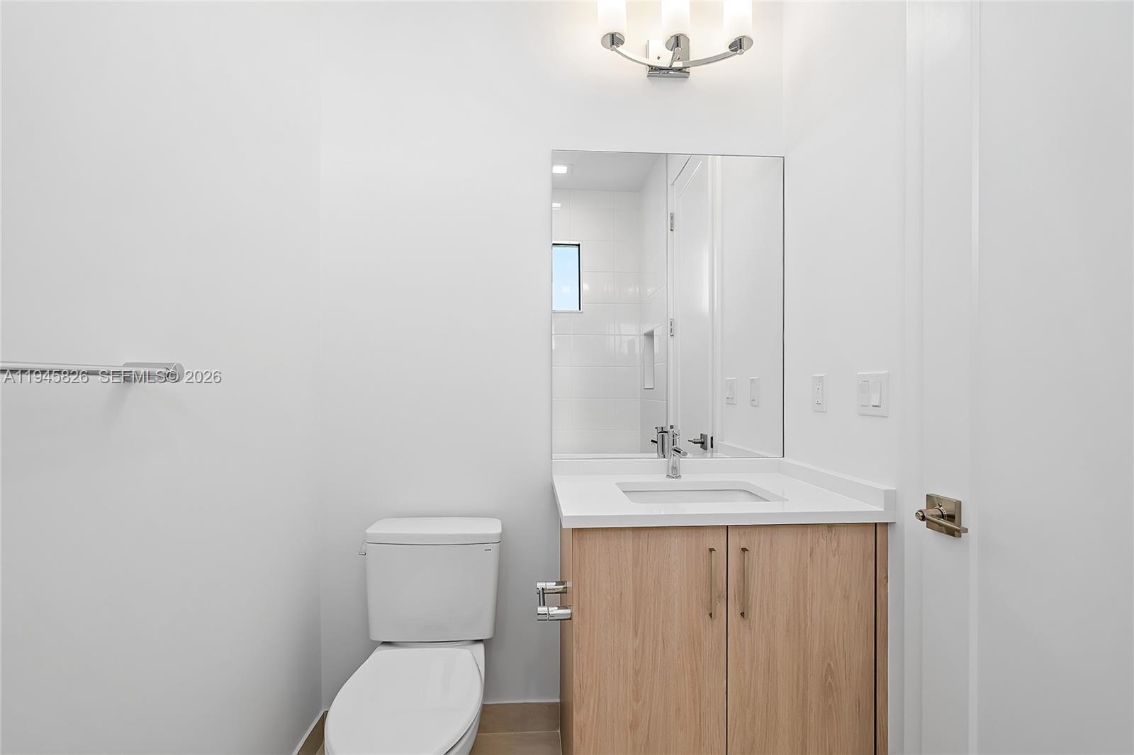 9362 Tulip Leaf Court Boca Raton, FL 33434 - Photo 30 of 80 a bathroom with a toilet sink and mirror