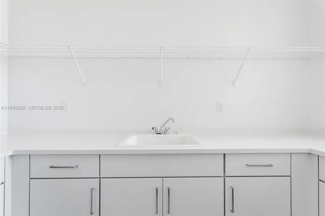 a kitchen with a sink and a toilet
