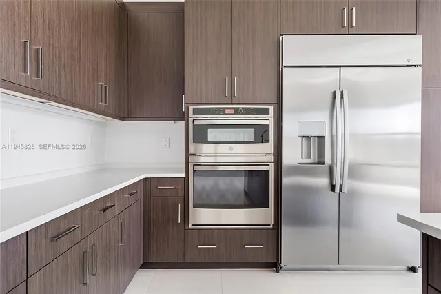 a kitchen with stainless steel appliances a sink and a large window