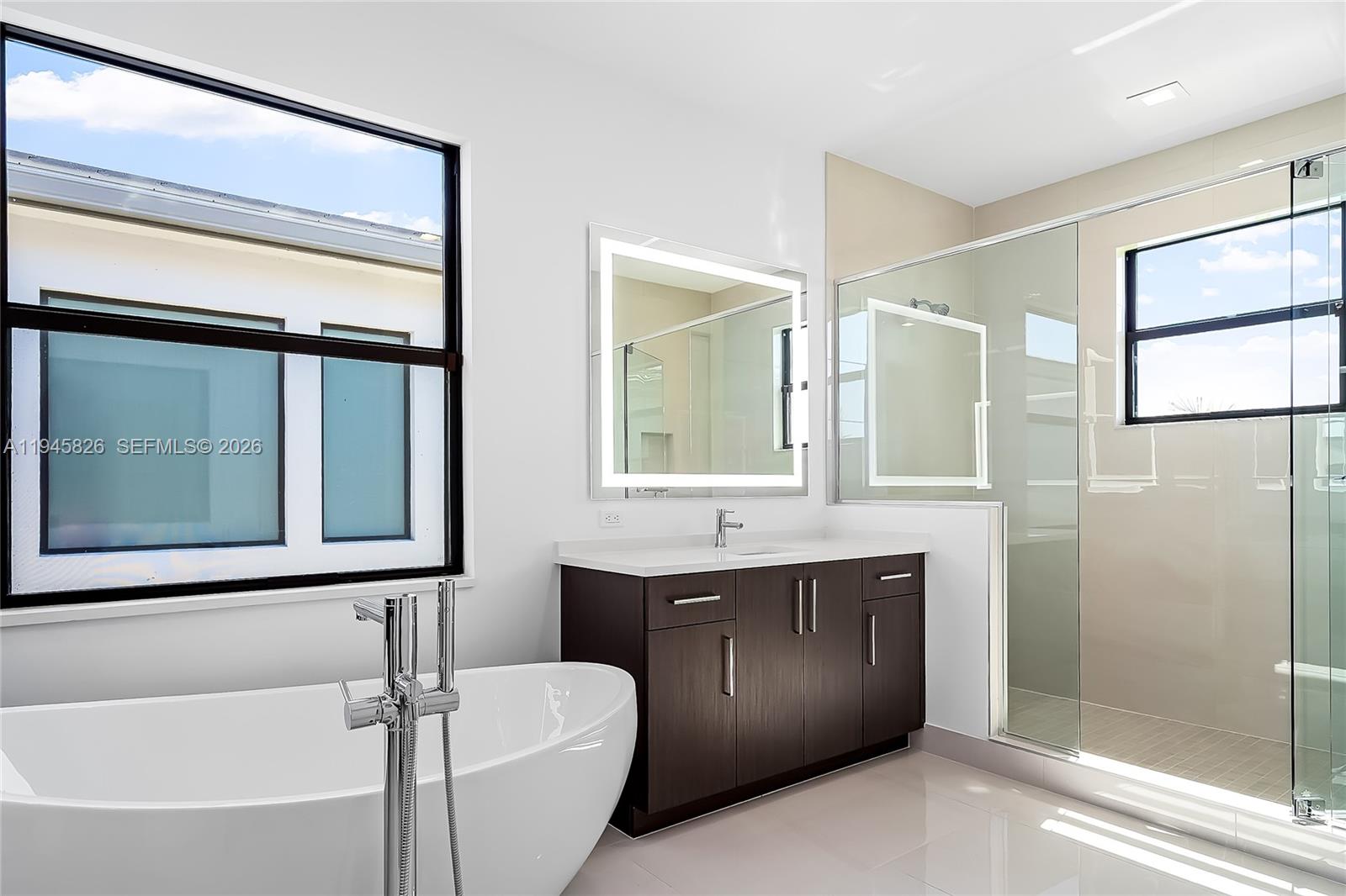 9362 Tulip Leaf Court Boca Raton, FL 33434 - Photo 51 of 80 a bathroom with a double vanity sink toilet mirror and bathtub