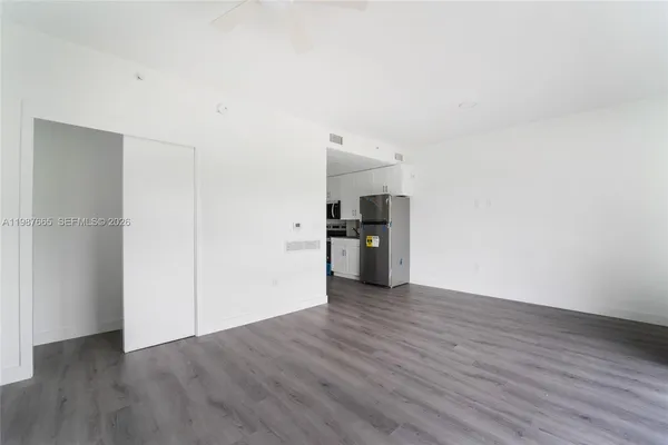 a view of a kitchen with a sink and a refrigerator