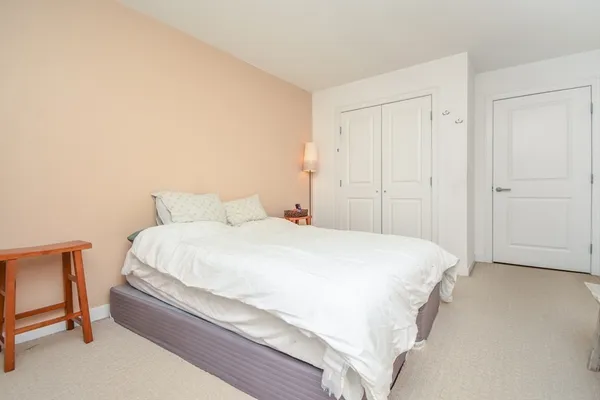 a bedroom with a bed and chair