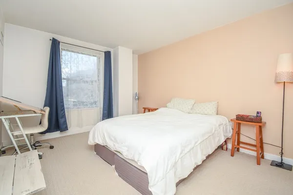 a bedroom with a bed and chair