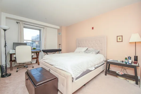 a bed room with a bed and a chair