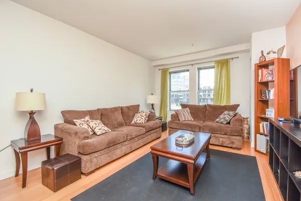 a living room with furniture and a lamp