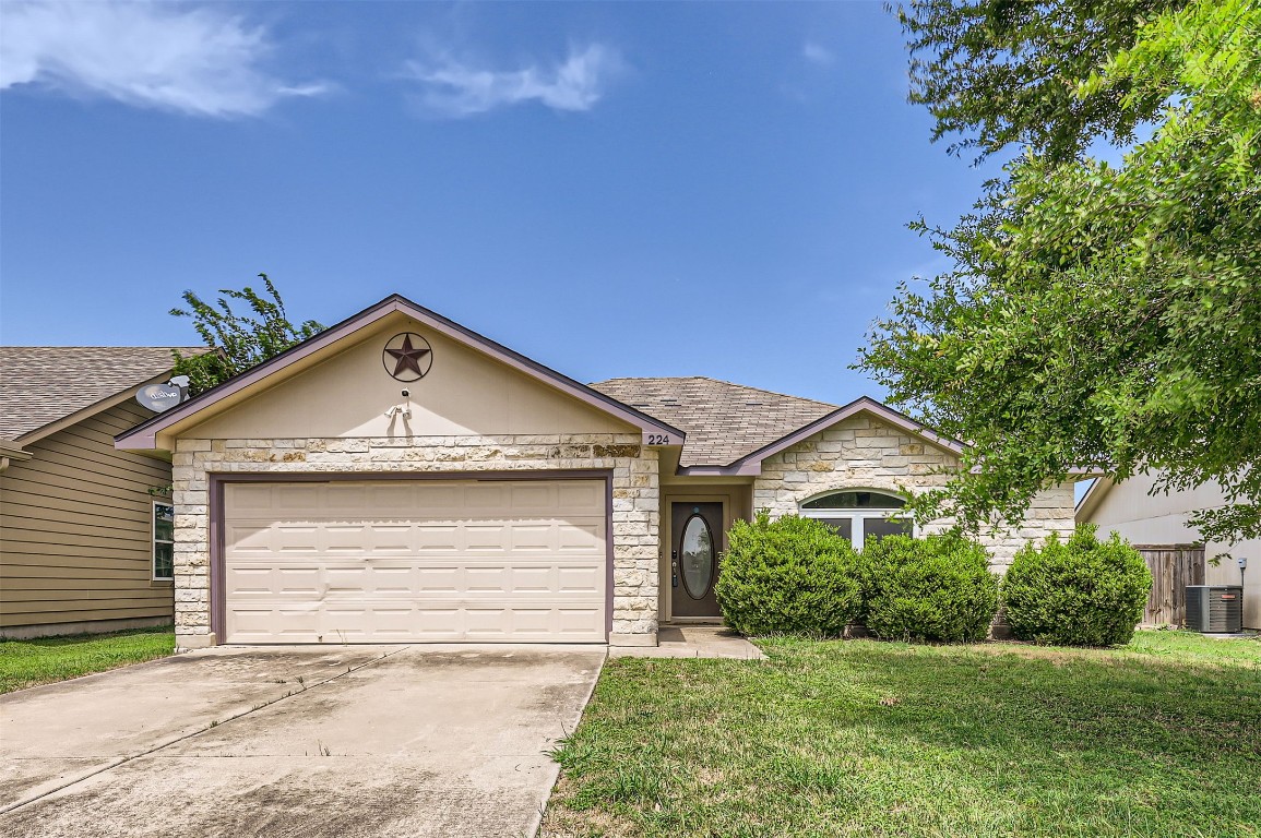 224 Copper Lane Jarrell, TX 76537 - Photo 2 of 11 a front view of a house with a yard and garage