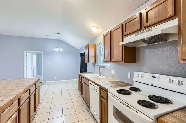 a kitchen with a stove and a sink