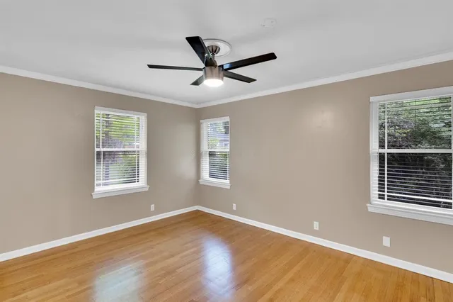 a view of a room with wooden floor and windows