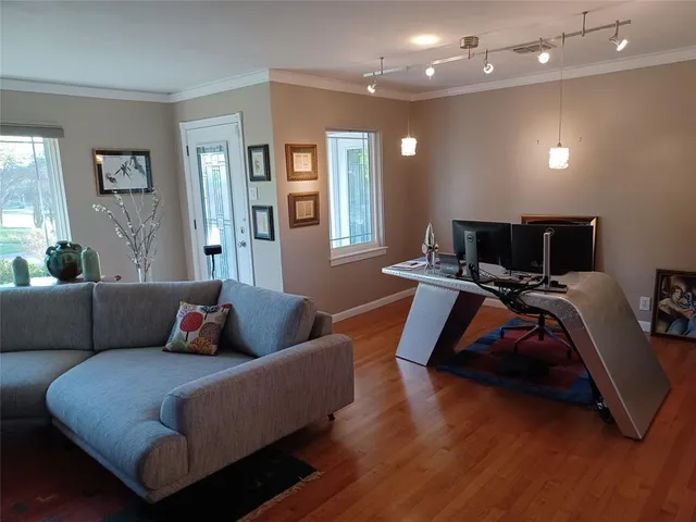 a living room with furniture and wooden floor