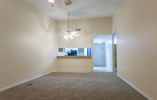 a view of a kitchen with a sink and chandelier fan
