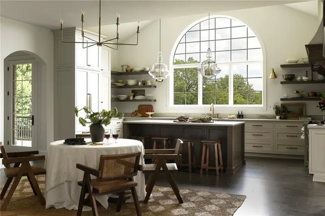 a kitchen with a table chairs sink and cabinets