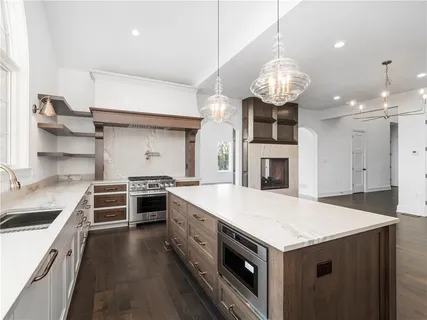 a kitchen with a stove and a chandelier