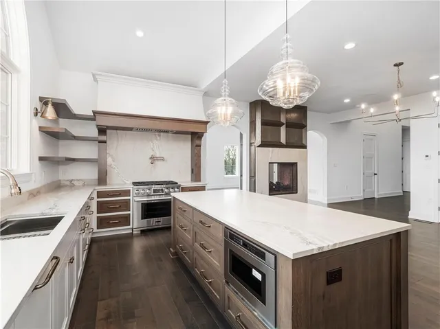 a kitchen with a stove and a chandelier