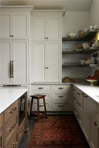 a kitchen with white cabinets and white appliances