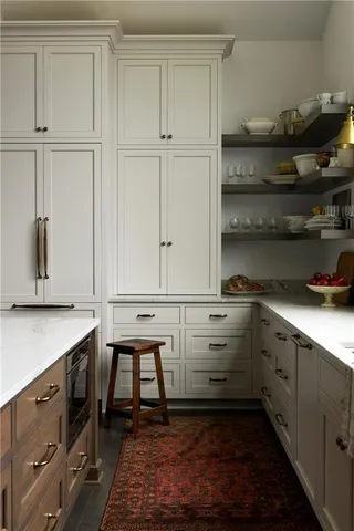 a kitchen with white cabinets and white appliances