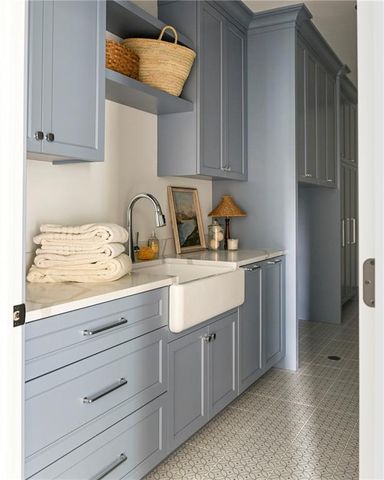 a sink with cabinets and window