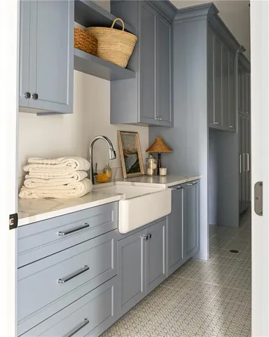 a sink with cabinets and window