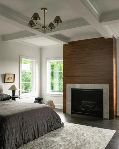 a bedroom with a bed a fireplace and window