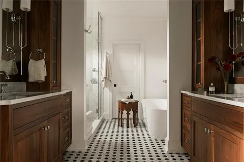 a bathroom with a sink a toilet a mirror and shower