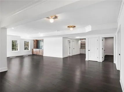 a view of a livingroom with wooden floor and windows