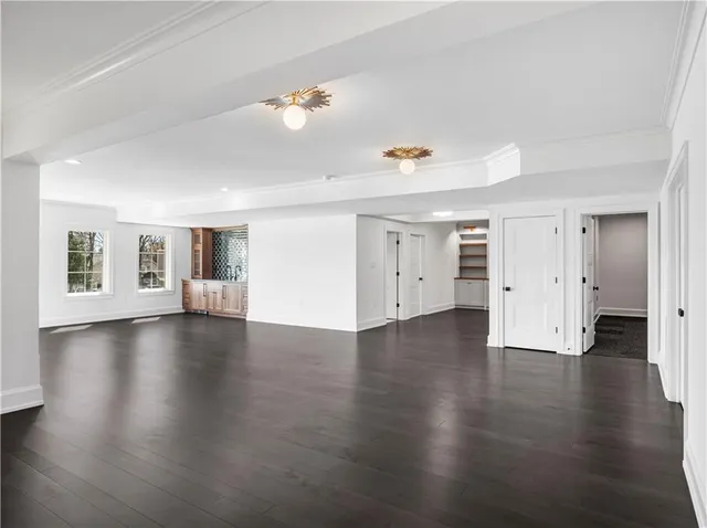 a view of a livingroom with wooden floor and windows