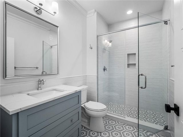 a bathroom with a sink toilet and shower