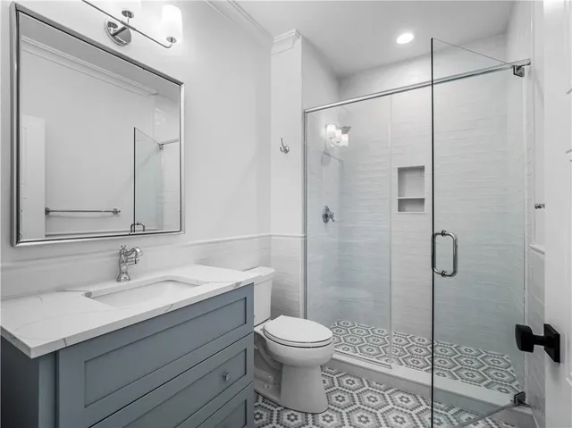 a bathroom with a sink toilet and shower