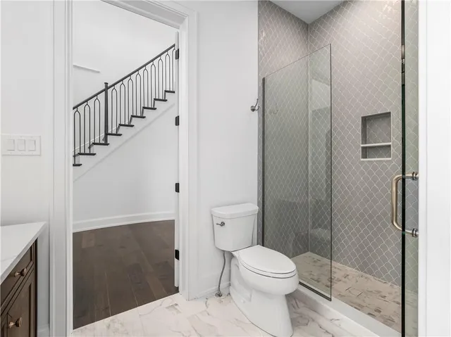 a bathroom with a toilet and a shower