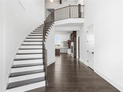 a view of entryway and hall with wooden floor