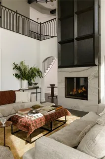 a living room with furniture fireplace and a flat screen tv