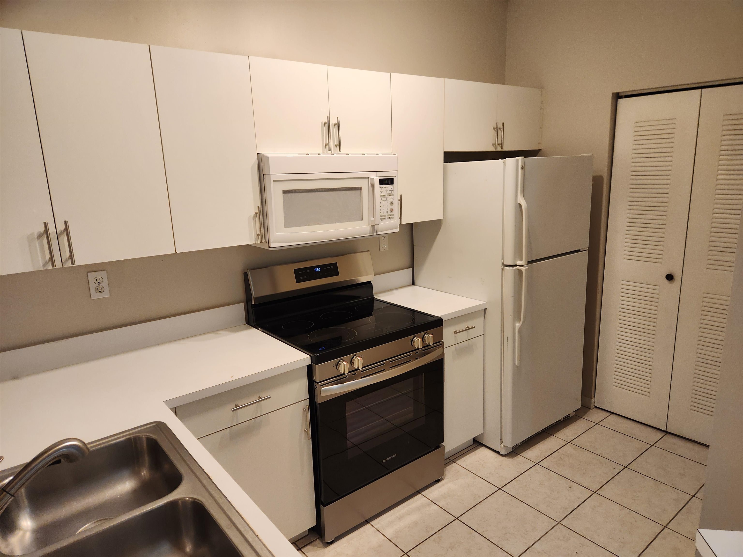 510 Florida Club Boulevard, Unit 101 St. Augustine, FL 32084 - Photo 14 of 37 a kitchen with white cabinets and white appliances