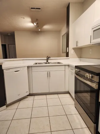 a kitchen with a stove a sink and a refrigerator