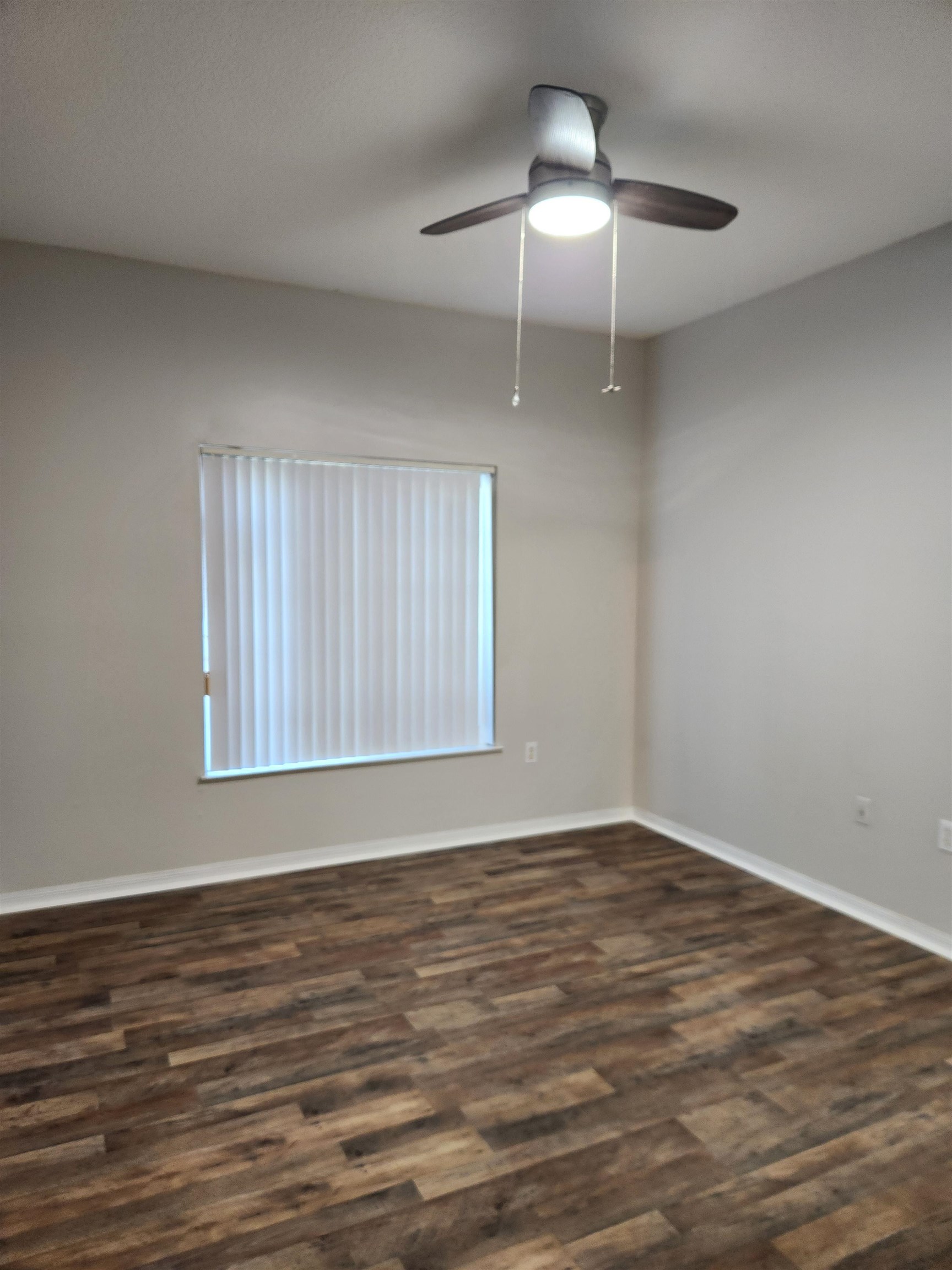 510 Florida Club Boulevard, Unit 101 St. Augustine, FL 32084 - Photo 17 of 37 a view of an empty room with wooden floor and a window