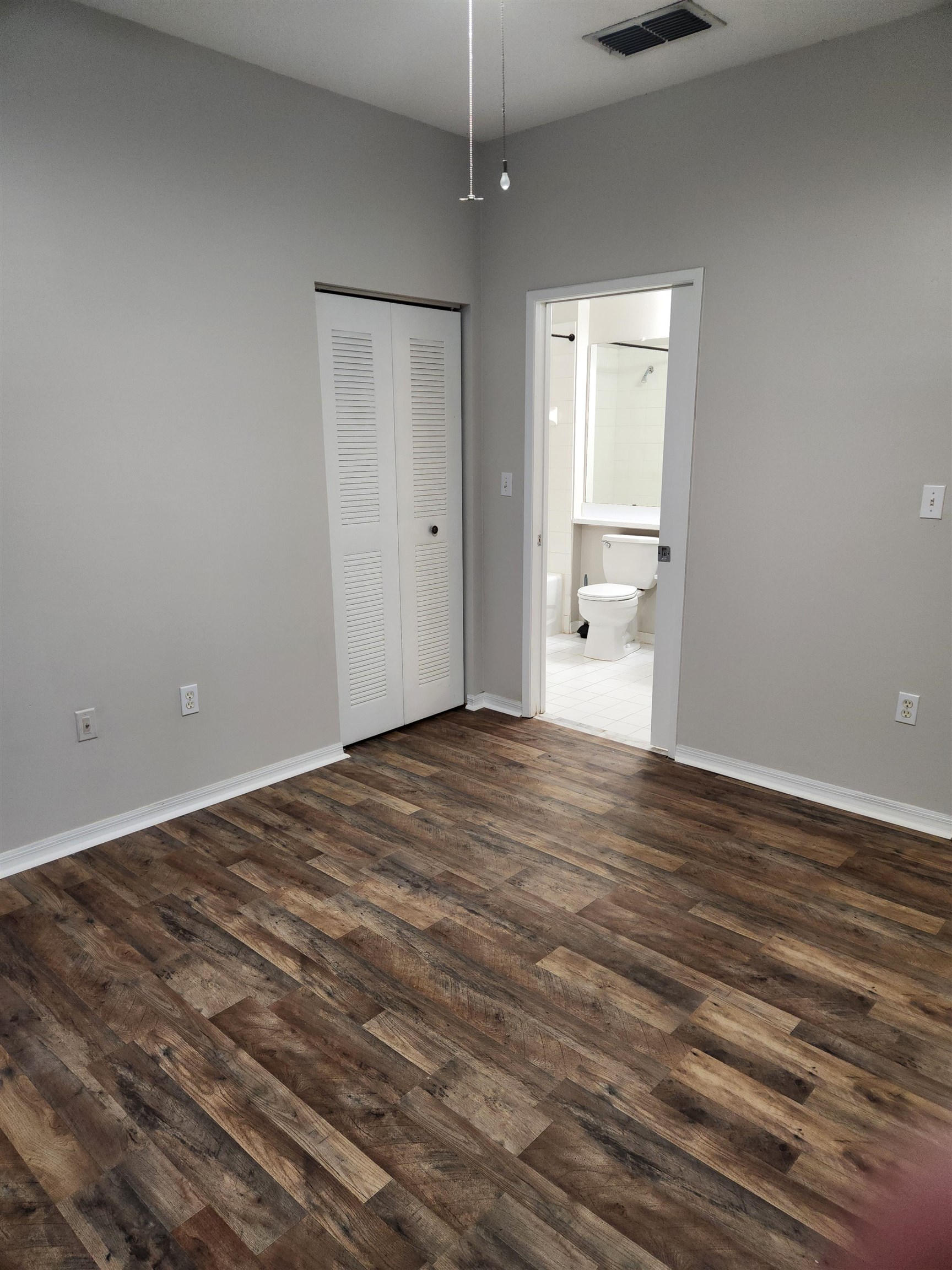 510 Florida Club Boulevard, Unit 101 St. Augustine, FL 32084 - Photo 18 of 37 a view of empty room with wooden floor and window