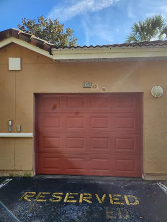 a view of water heater room with wooden floor