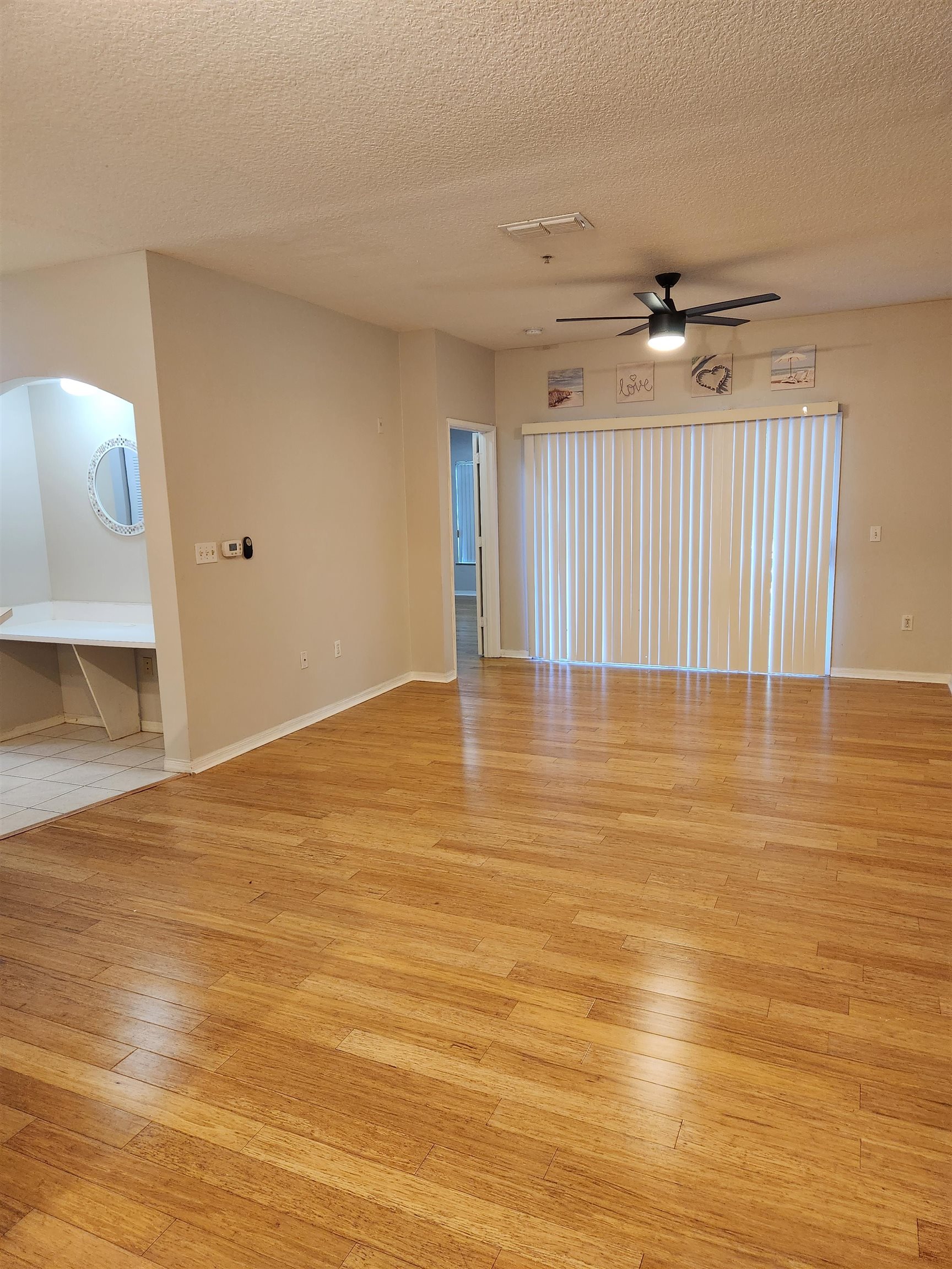 510 Florida Club Boulevard, Unit 101 St. Augustine, FL 32084 - Photo 6 of 37 a view of empty room with wooden floor and fan