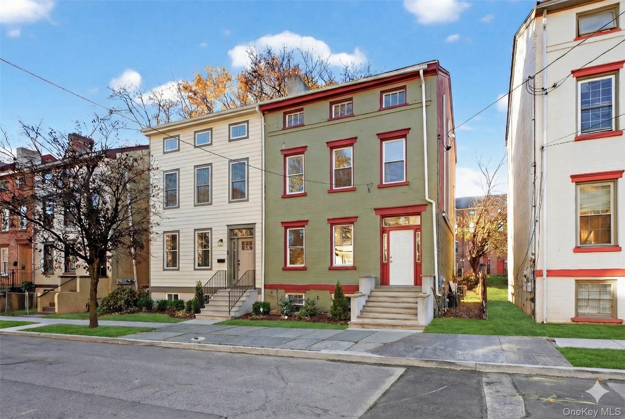 a front view of a residential apartment building with a yard
