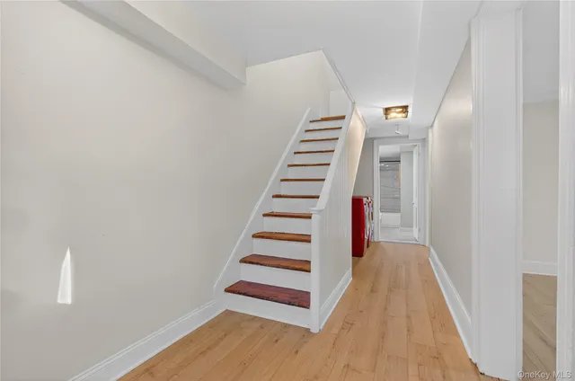 a view of a hallway with wooden floor and entryway