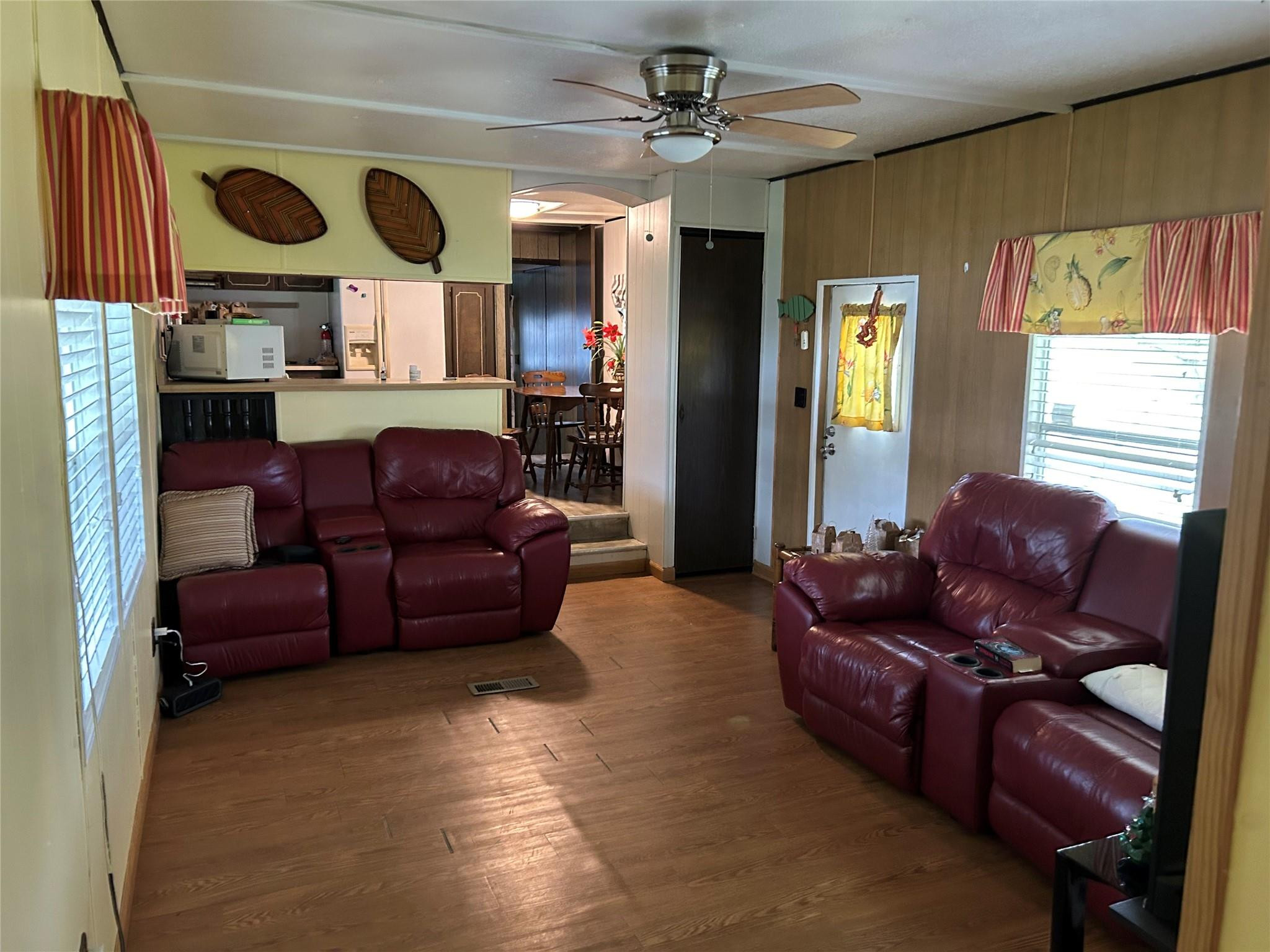 1379 Chobee Street Okeechobee, FL 34974 - Photo 4 of 13 a living room with furniture kitchen view and a large window