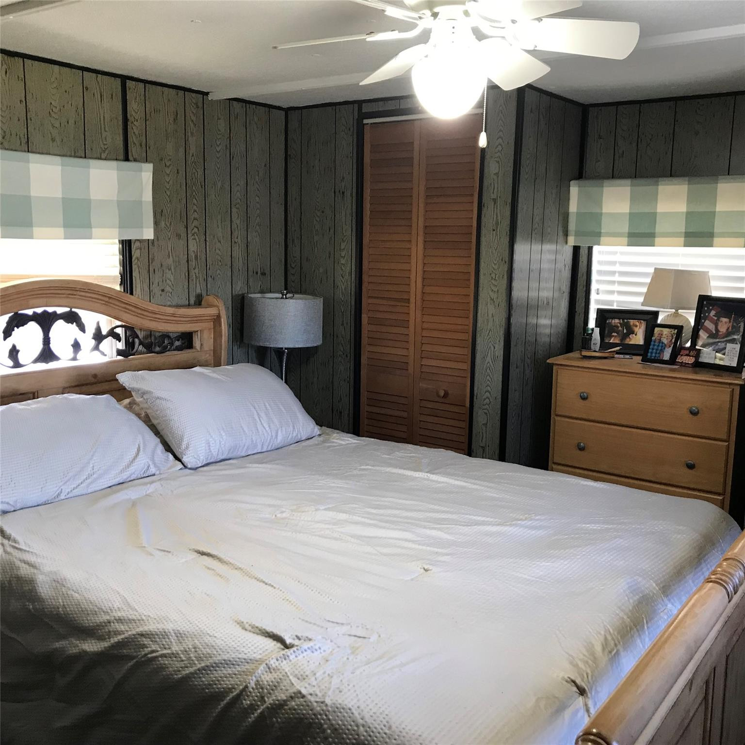 1379 Chobee Street Okeechobee, FL 34974 - Photo 7 of 13 a bedroom with a bed and a mirror