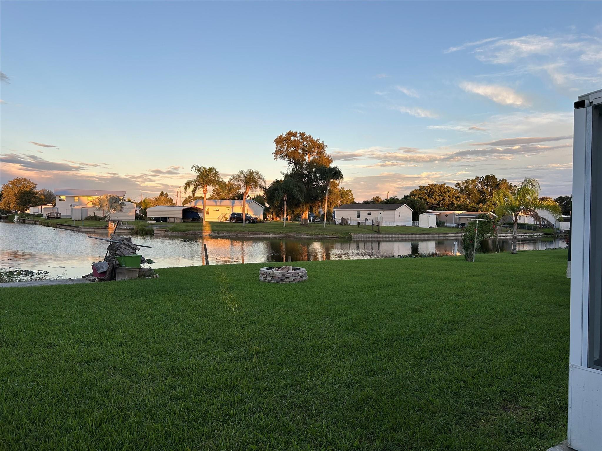 1379 Chobee Street Okeechobee, FL 34974 - Photo 10 of 13 a front view of a house with a garden and lake view