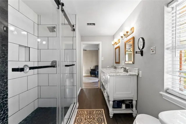 a bathroom with a granite countertop sink and a mirror