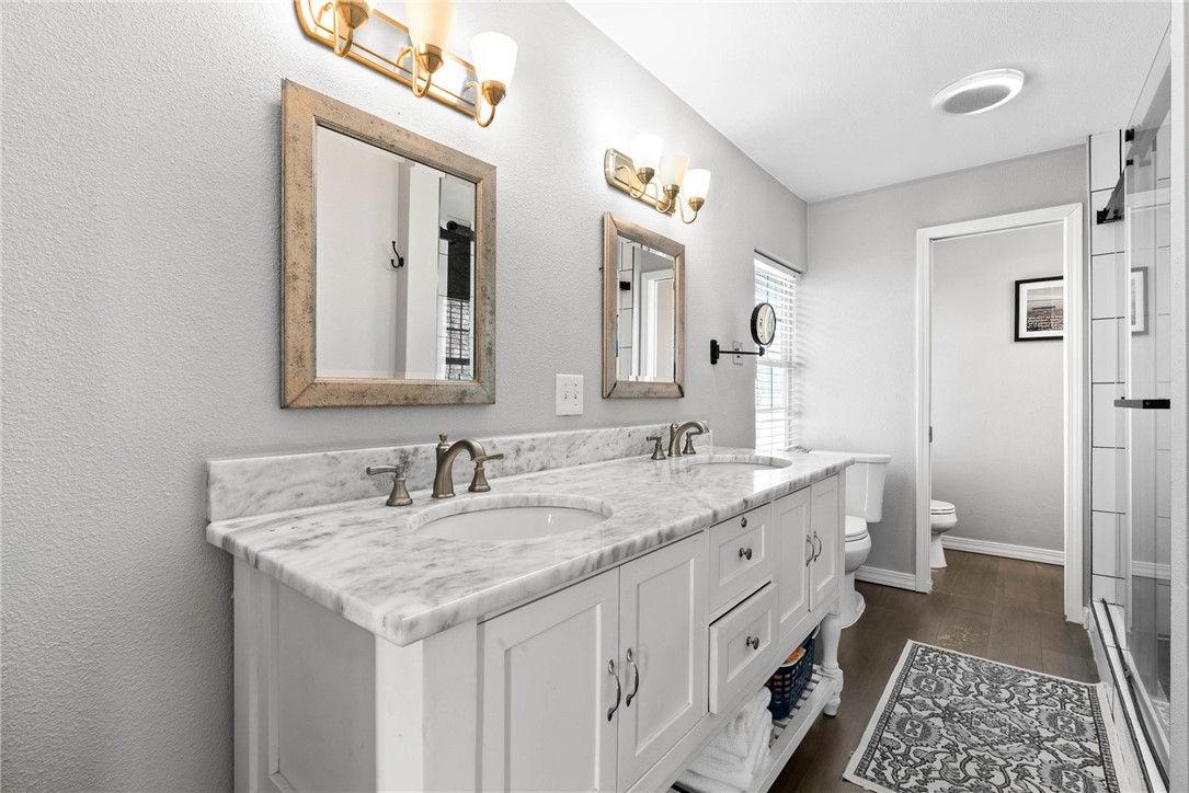 302 Cole Street Corpus Christi, TX 78404 - Photo 23 of 40 a bathroom with a granite countertop sink and a mirror